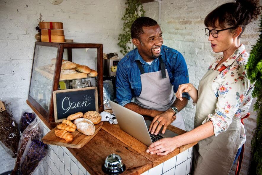Two small-business owners working together in their bakery