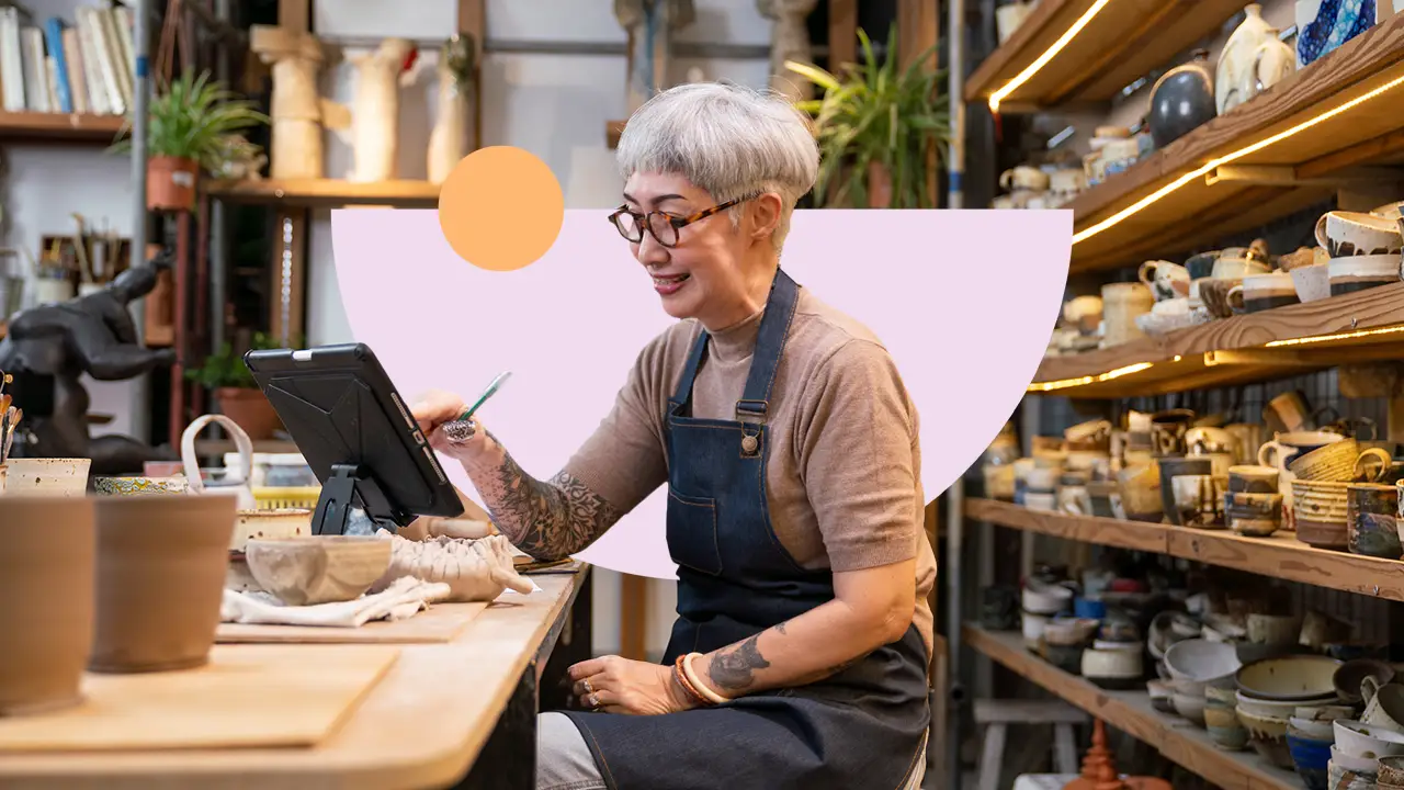 A studio owner reviewing project work on a tablet